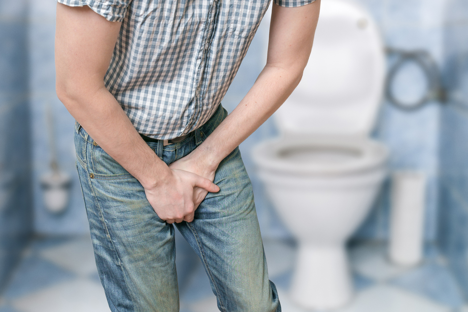 A girl wearing black sandals pissing in the common WC