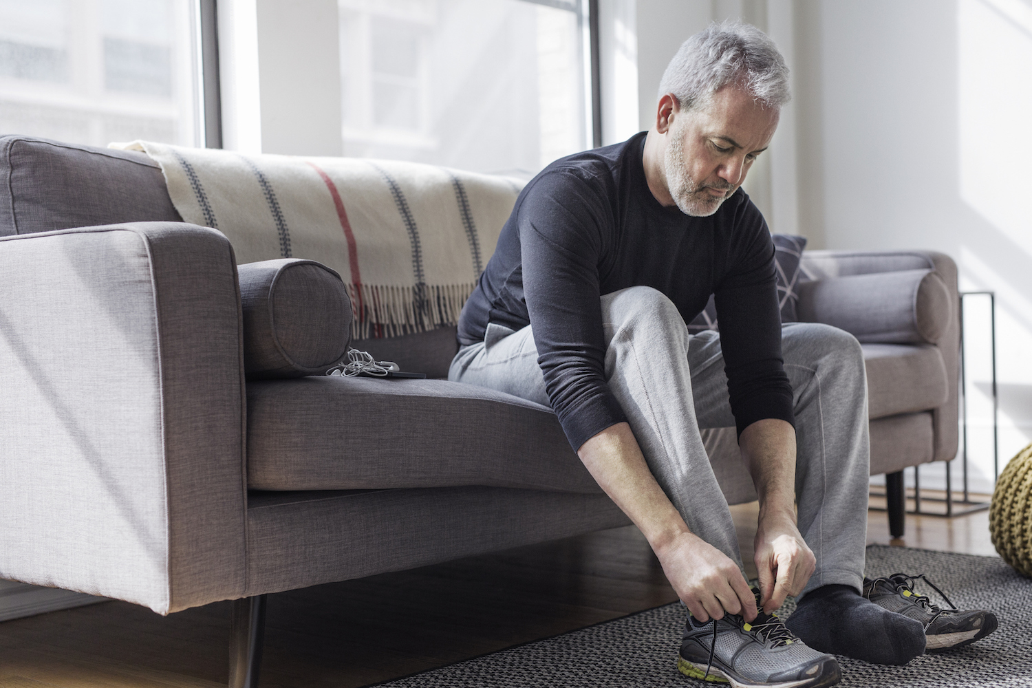 man tying shoelace