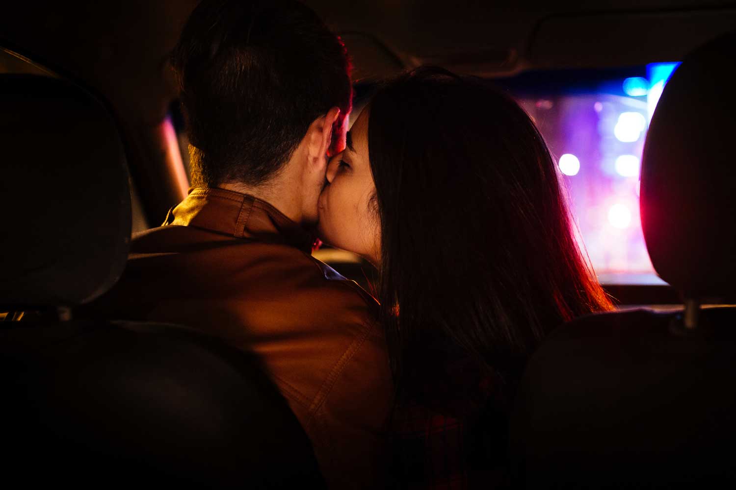 Woman whispering in man's ear