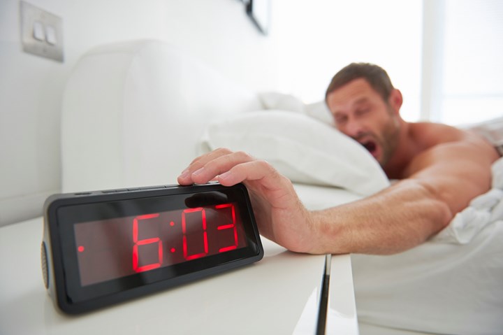 man hitting alarm